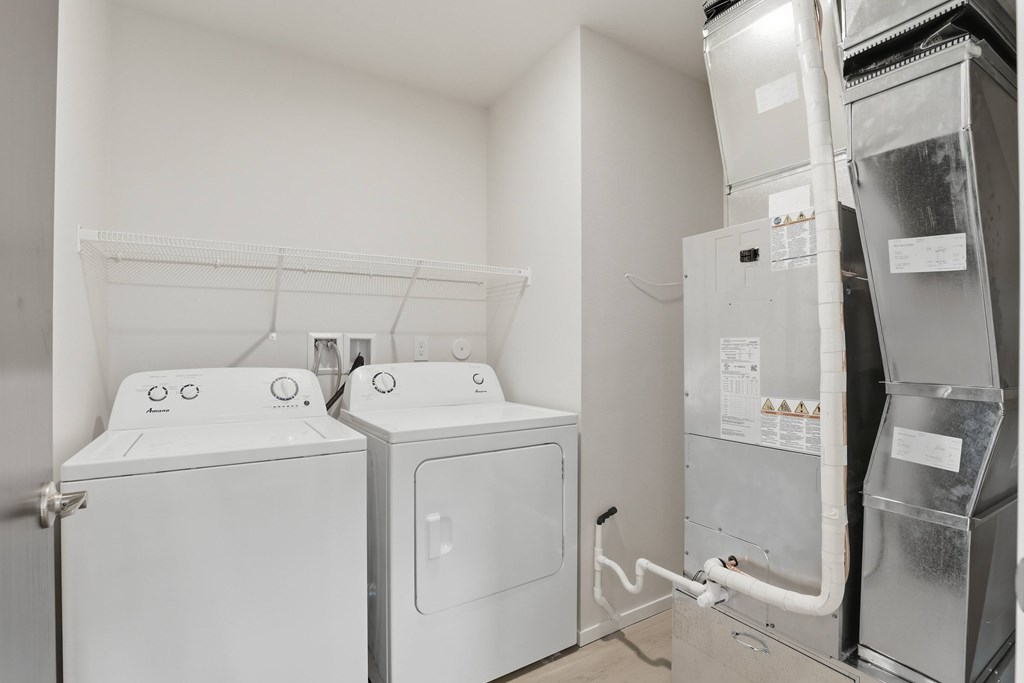 A white washing machine and dryer in a small laundry room.
