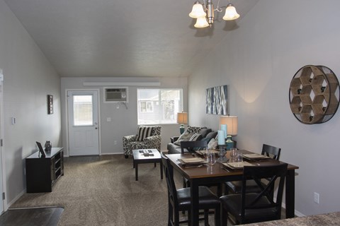 an open living room and dining room with a table and chairs