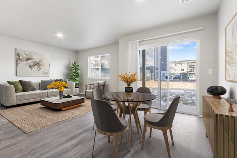 A modern dining room with a glass table and chairs.