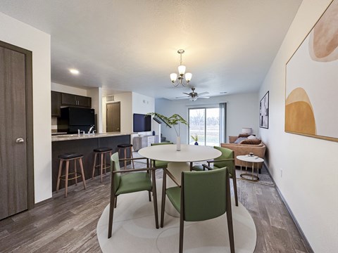 A modern dining room with a table set for two.