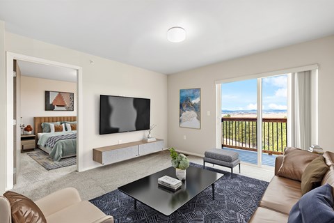 A living room with a television, a couch, and a coffee table.