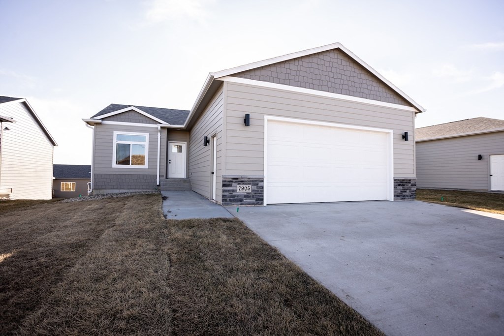 a white house with a garage and a driveway