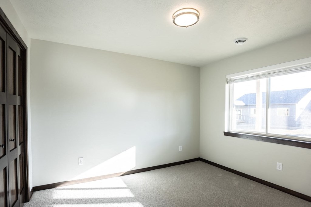 an empty room with a window and a door