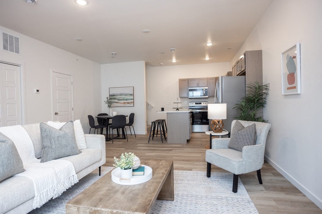 a living room with couches and chairs and a table