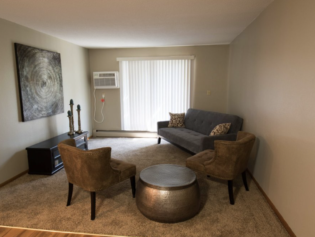 a living room with a couch and two chairs