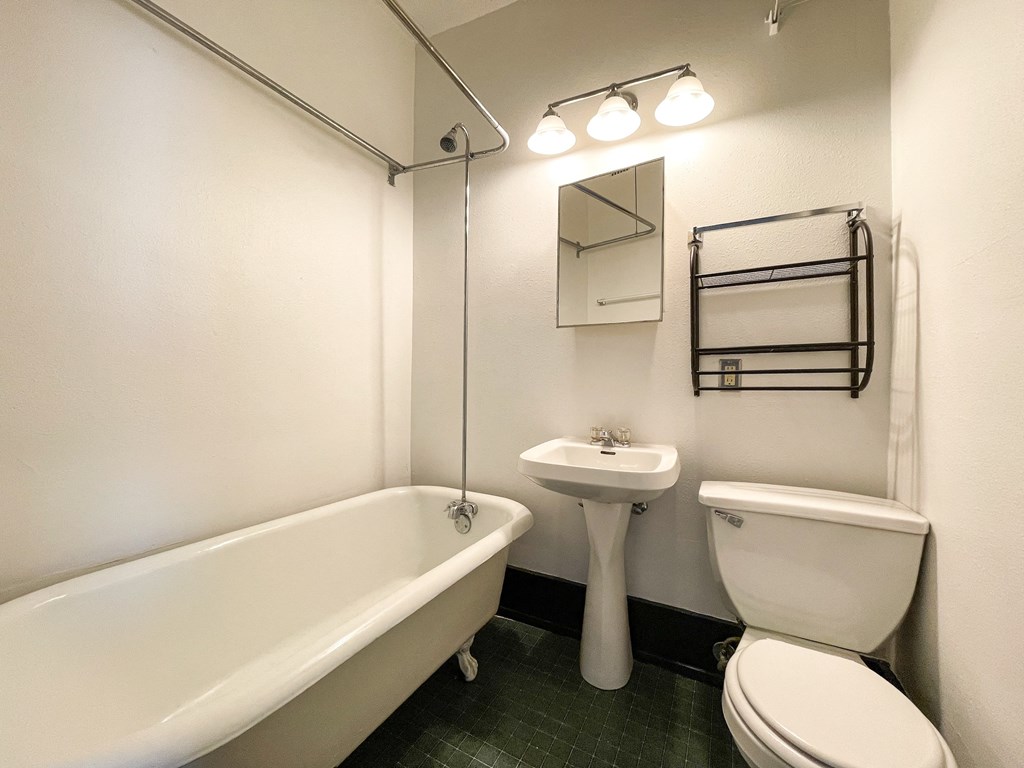 a bathroom with a toilet sink and a bath tub