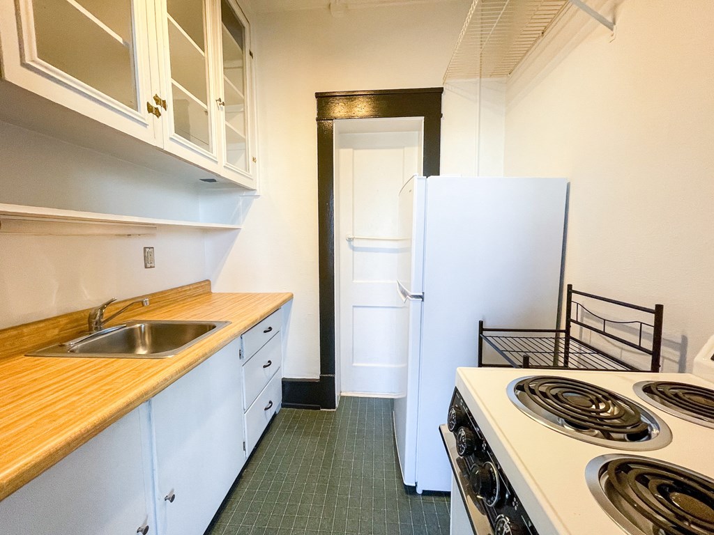 a kitchen with a stove and a refrigerator