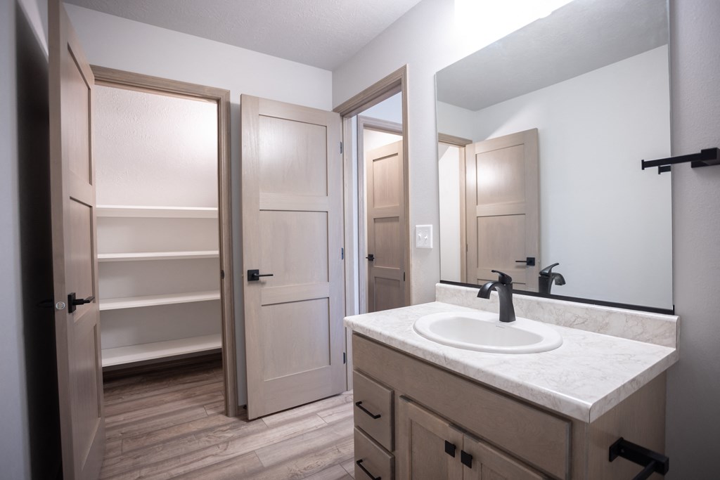 an empty bathroom with a sink and a mirror