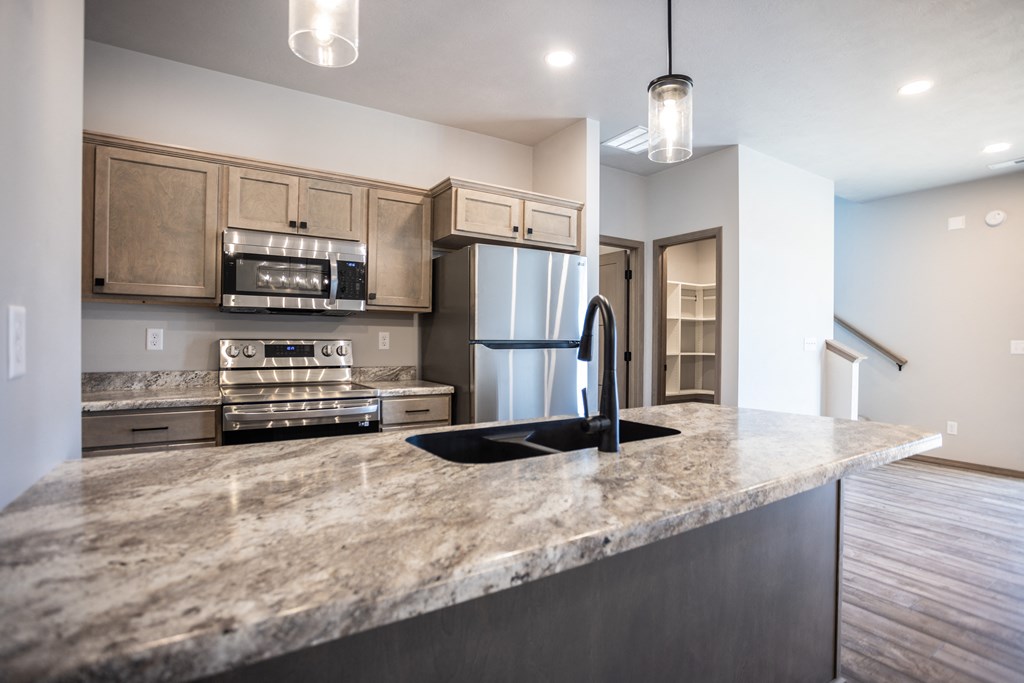 a kitchen with stainless steel appliances and a granite counter top
