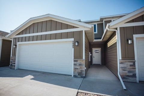 a white garage door in front of a house
