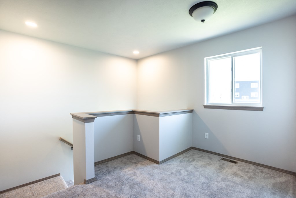 an empty room with white walls and a window