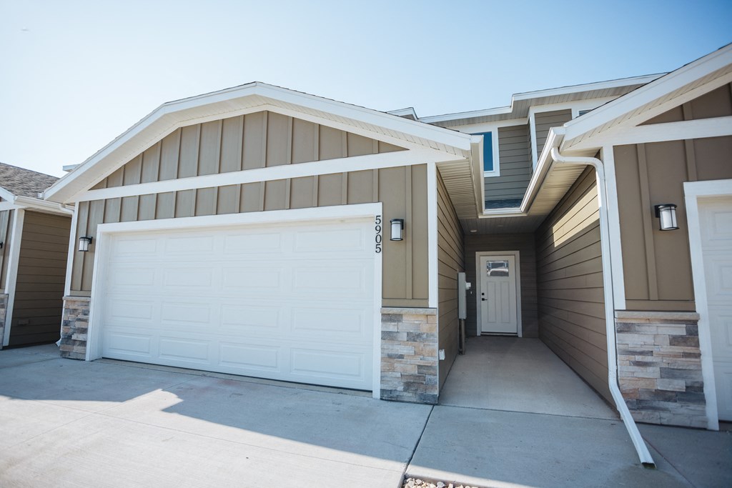the front of a house with a white garage door