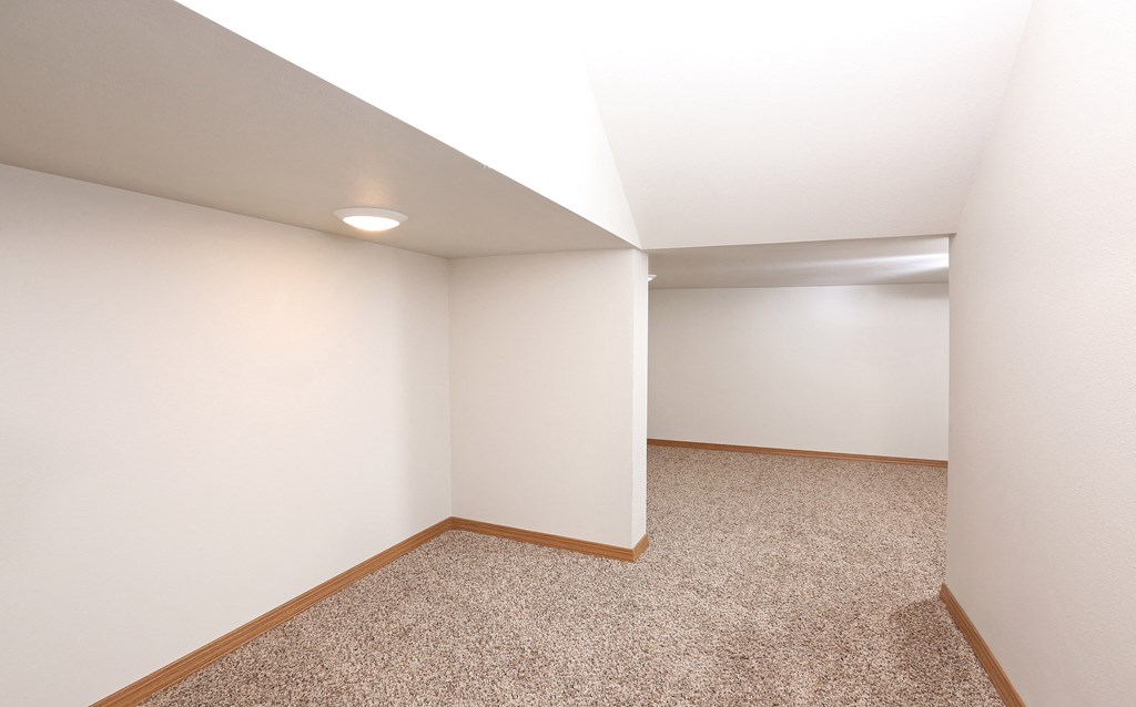 a empty room with carpet and white walls