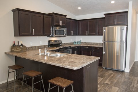 a kitchen with stainless steel appliances and granite counter tops