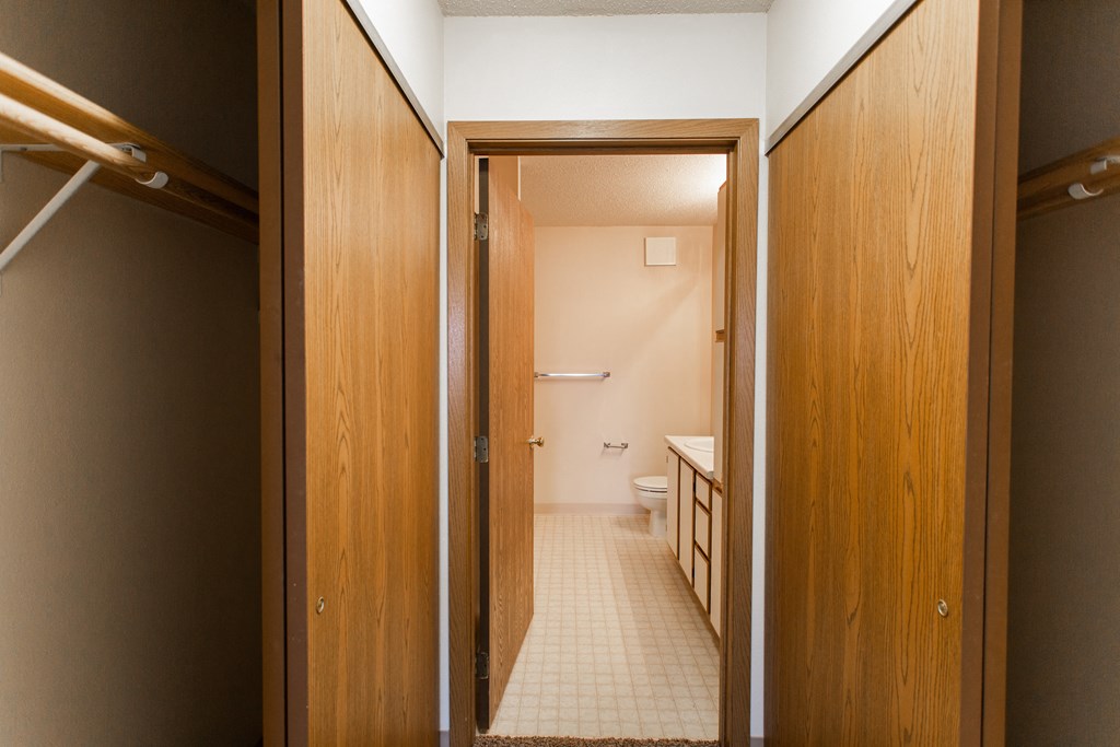 a bathroom with a toilet and a wooden door