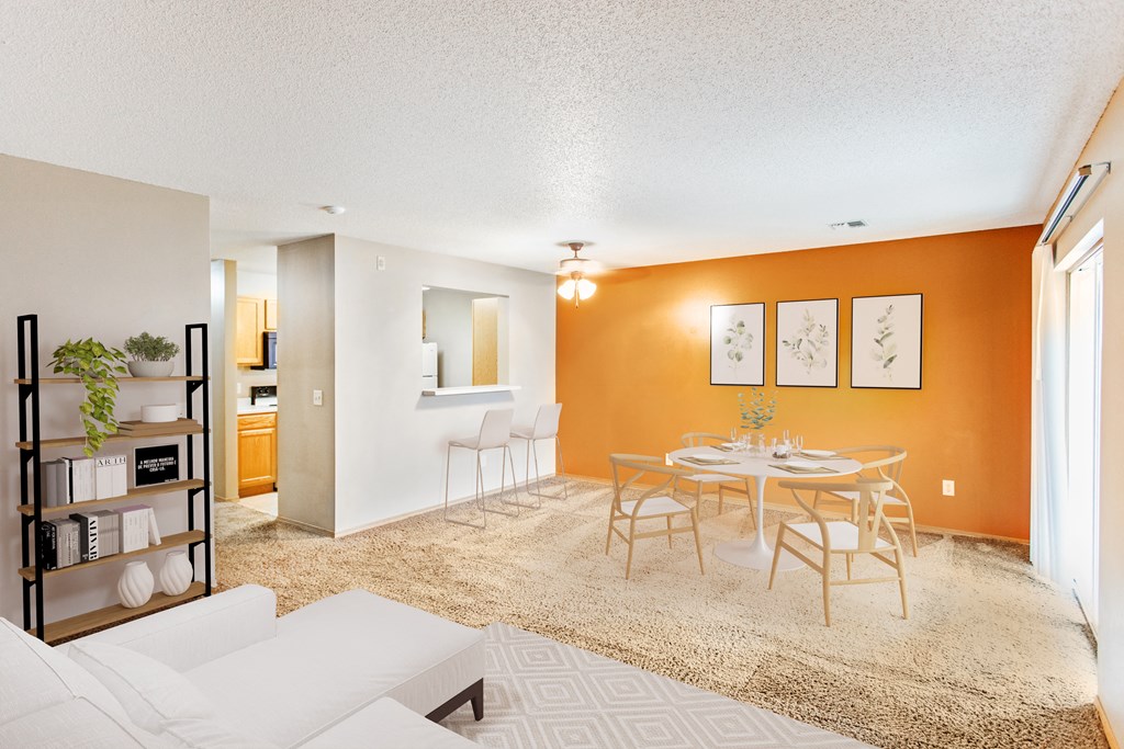 a living room and dining room with a table and chairs