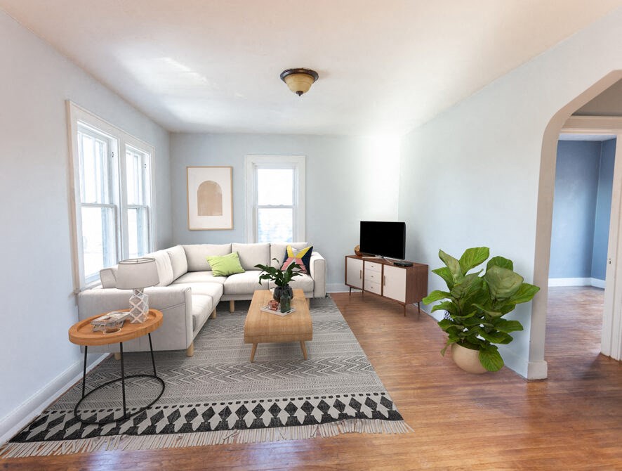 a living room with a white couch and a rug