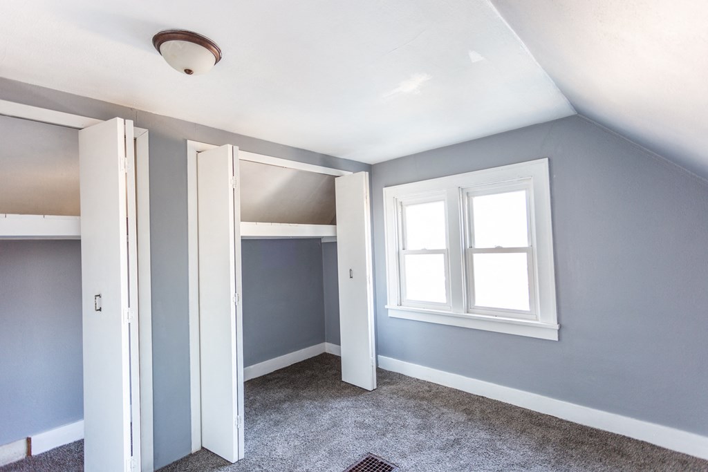 an empty room with blue walls and a window