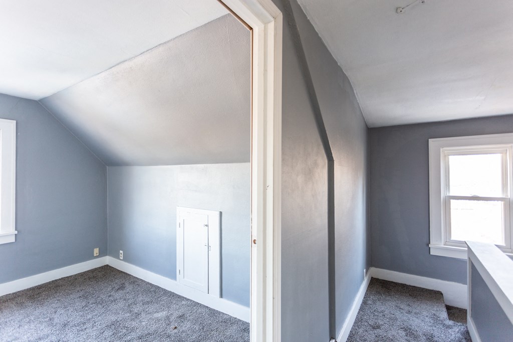 an empty room with blue walls and a white door