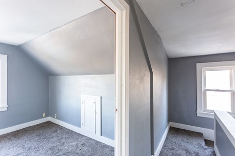 an empty room with blue walls and a white door