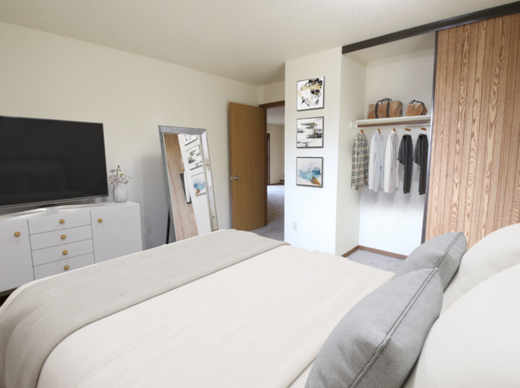 a bedroom with a bed and a tv and a closet
