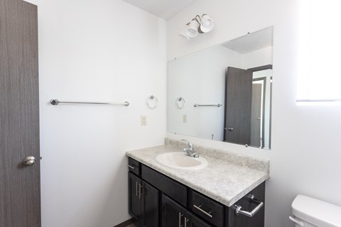 an empty bathroom with a sink and a mirror