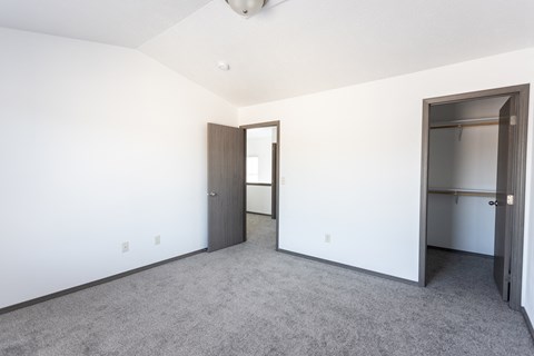 an empty room with a closet and a door
