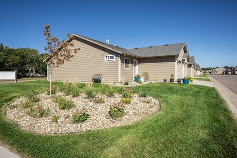 a house with a landscaped yard in front of it