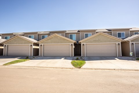 a row of houses with garages in front of them