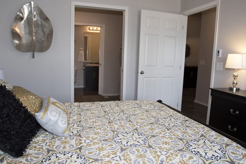 a bedroom with a large bed and a door to a bathroom