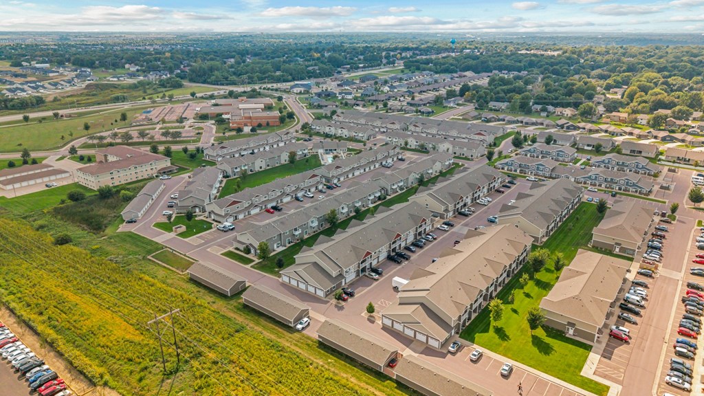 A bird's eye view of a residential area with houses and cars.