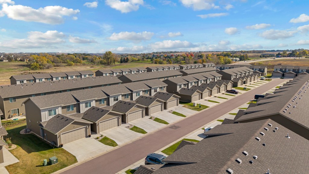 A large, well-maintained housing development with multiple houses and driveways.