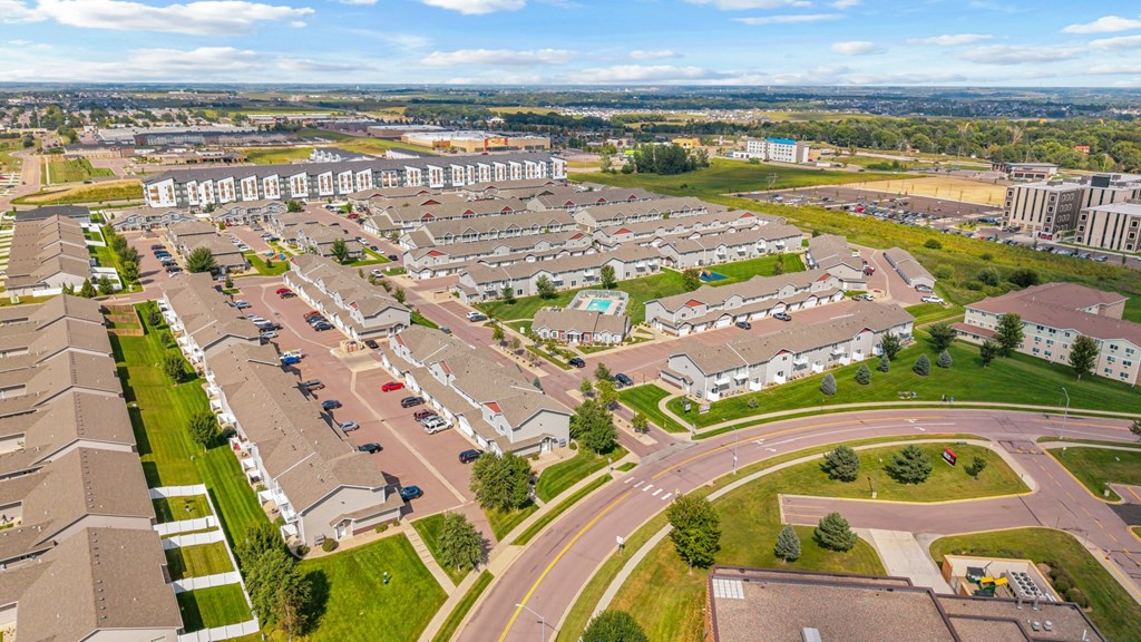 A residential area with houses and a parking lot.