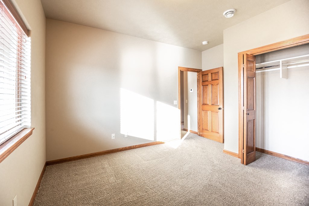 an empty room with a door and a window