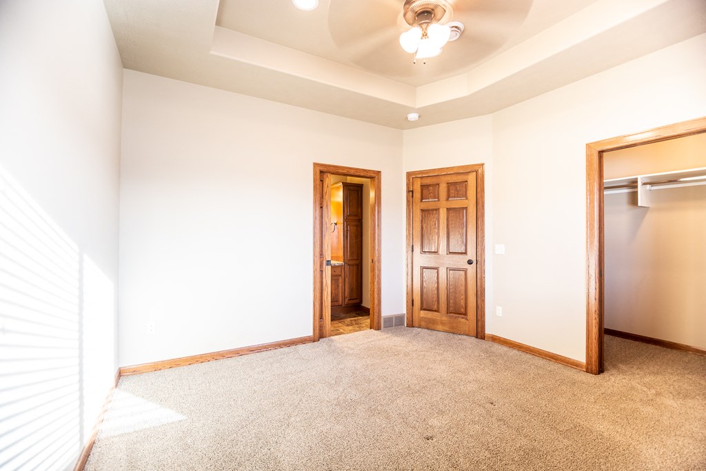 an empty room with a closet and a door to a bathroom