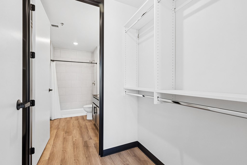 A white bathroom with a walk in shower and a toilet.