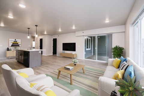 A modern living room with a white sofa, a wooden coffee table, and a TV.