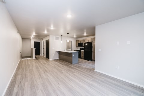 A kitchen area with a refrigerator, microwave, and oven.