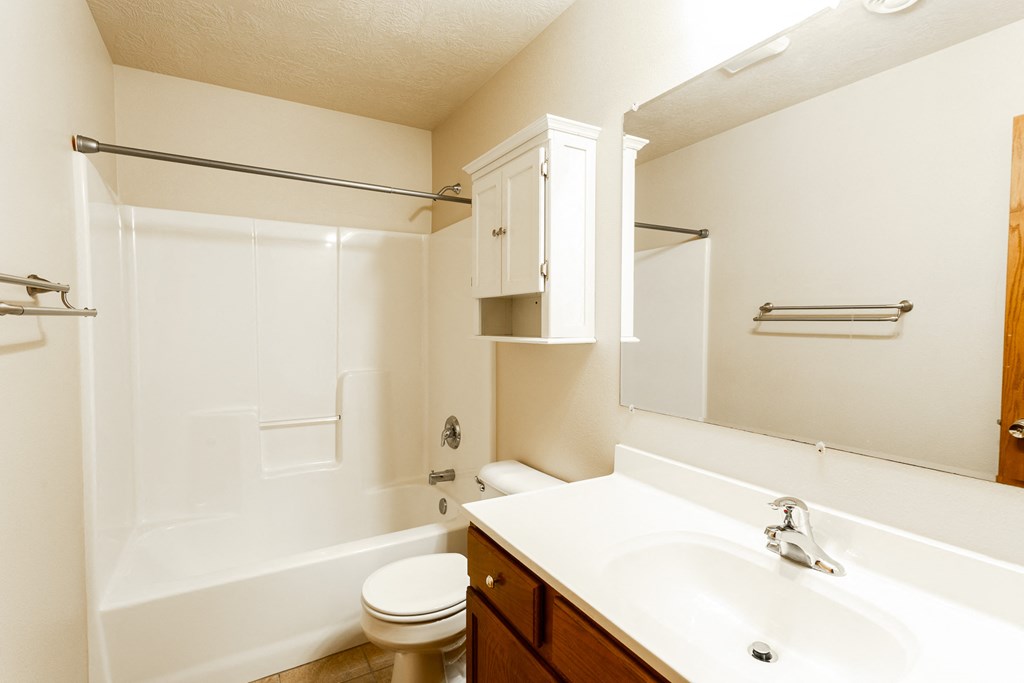 a bathroom with a sink toilet and bath tub