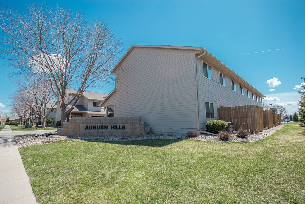 of a white house with a sidewalk and grass