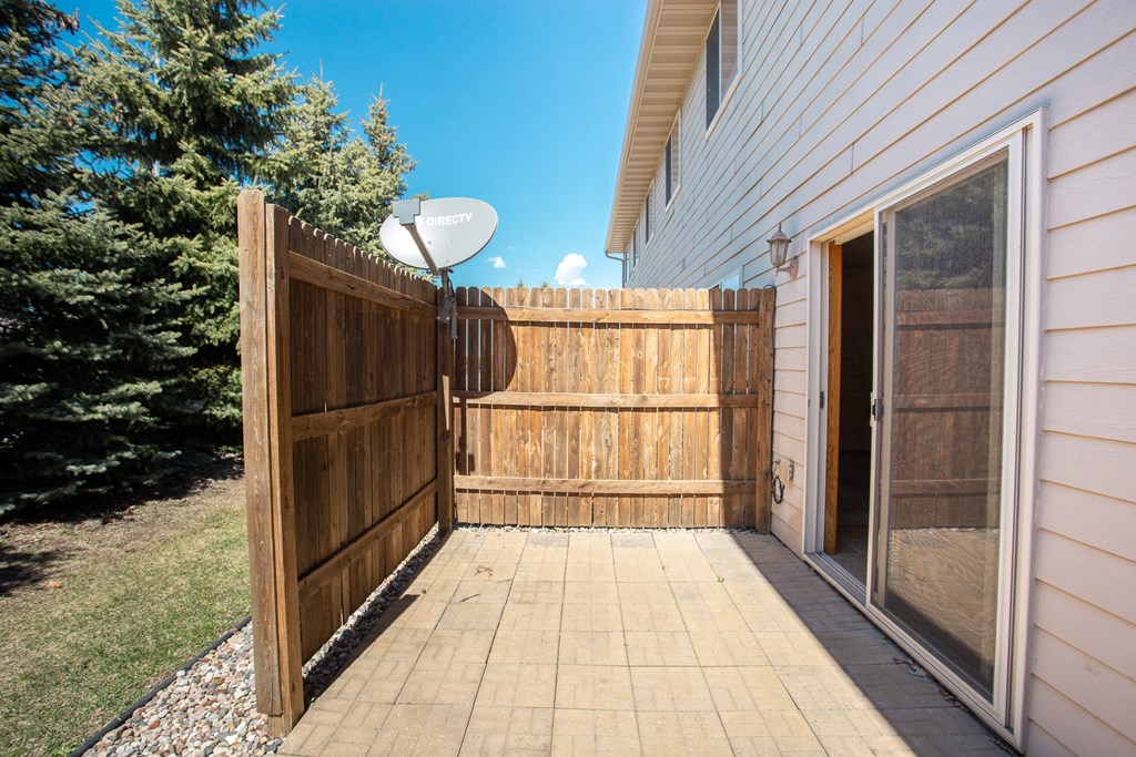 a wooden fence in a backyard next to a house