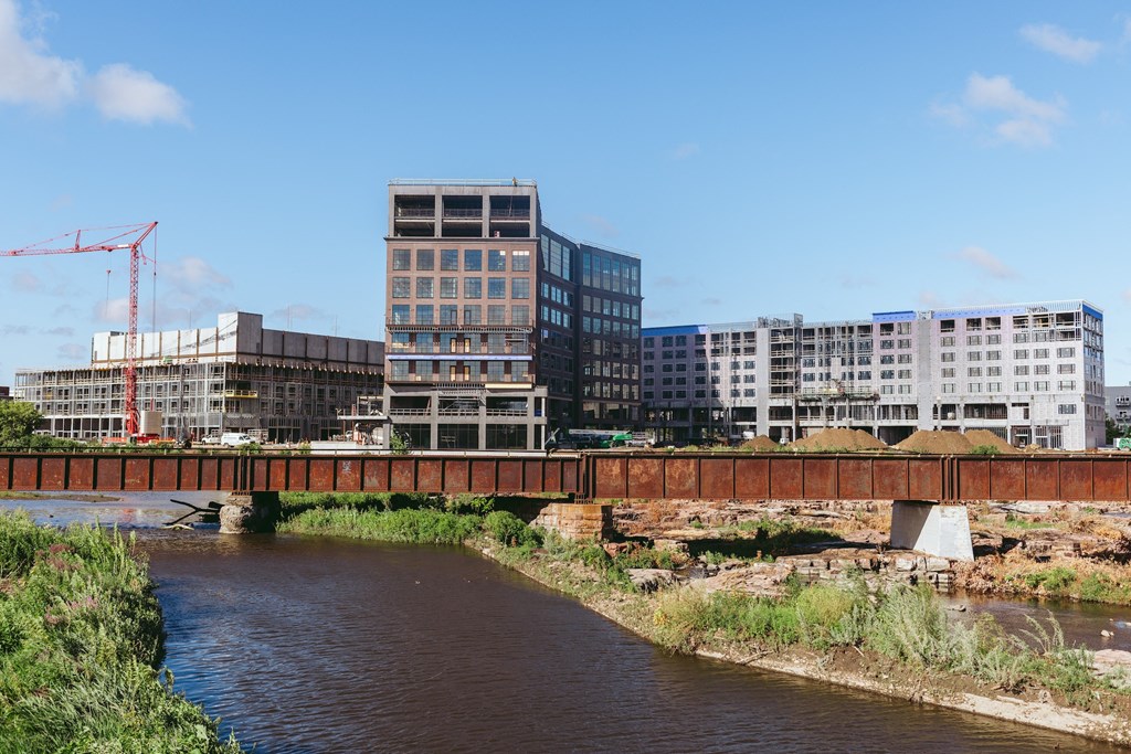 a bridge over a river with buildings in the background
