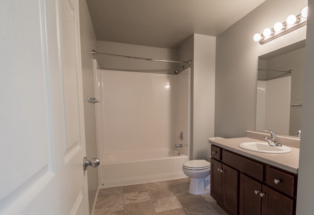 a bathroom with a shower and a sink and a toilet