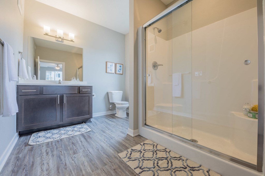 a bathroom with a shower and a sink and a toilet