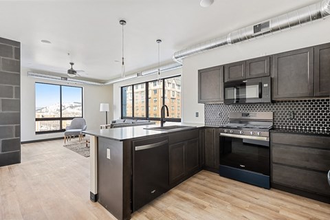 A kitchen with dark wood cabinets and a large island.