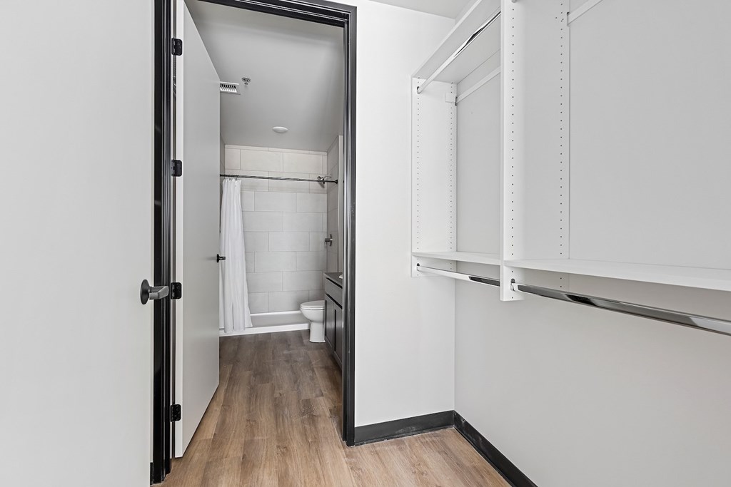 A white bathroom with a toilet, sink, and shower.
