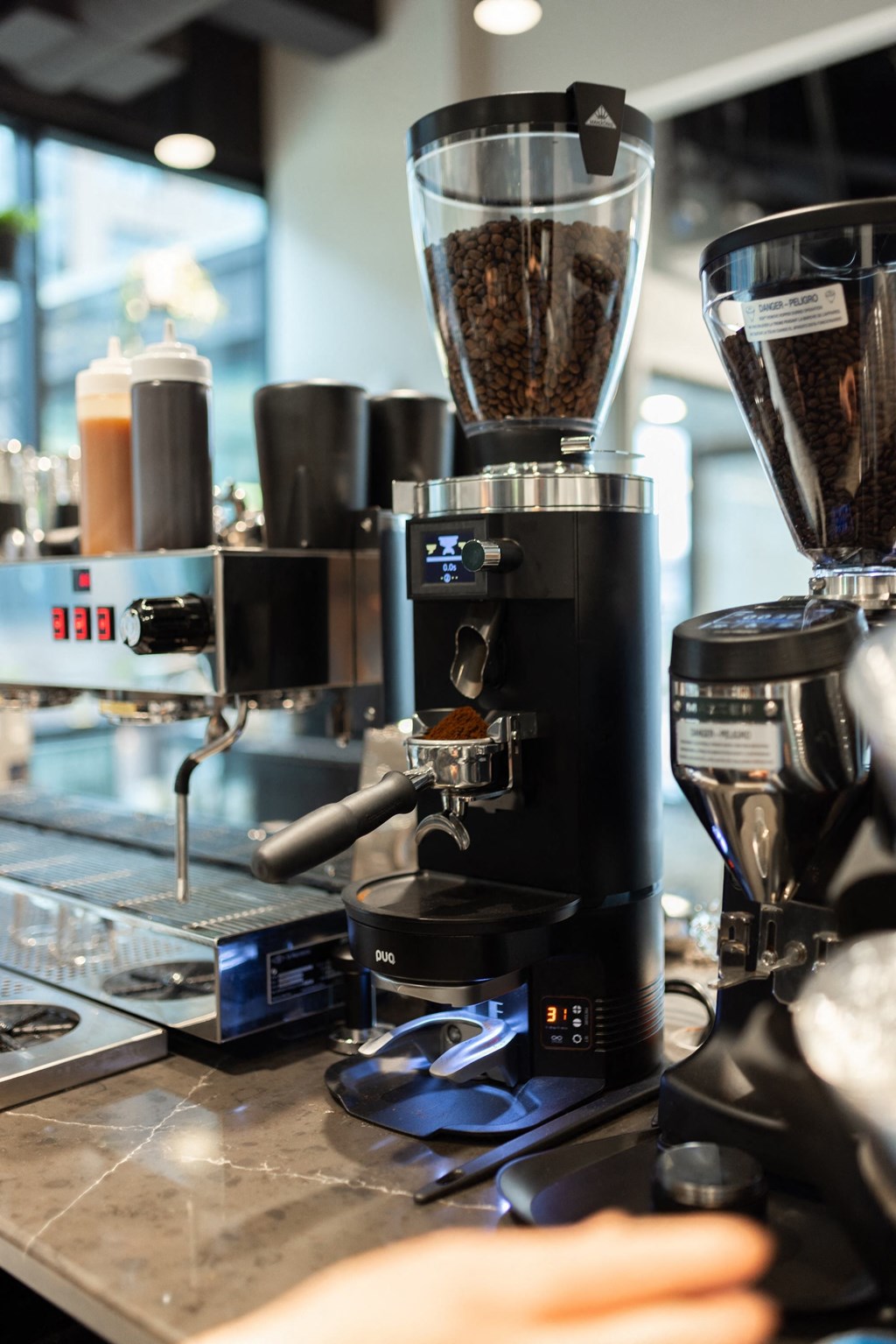 a coffee maker on a counter in a coffee shop