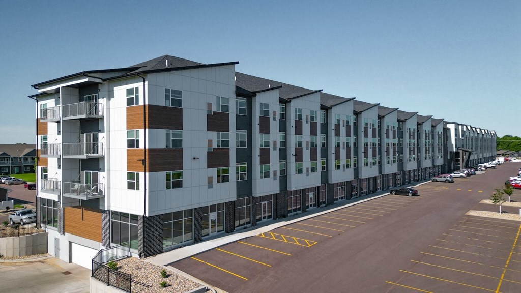 a large apartment building with a street in front of it