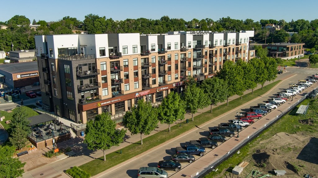 an aerial view of a building with a parking lot