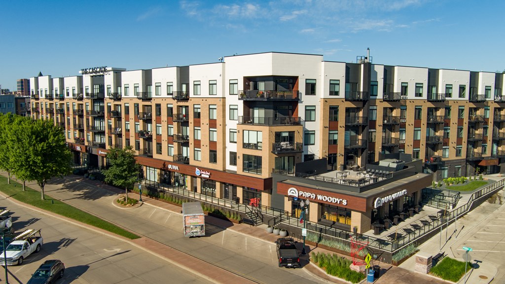 an aerial view of a large building with balconies and a brown and white building